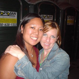 Two Friends Smiling Together at Outdoor Event