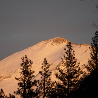 Snow-Covered Peak Bathed in Golden Alpenglow