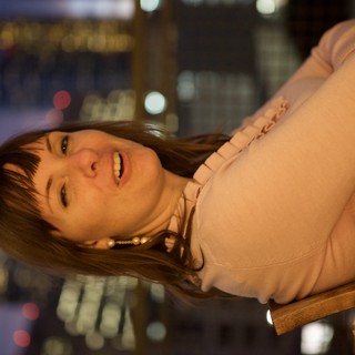 Penelope Smiling Against a City Nightscape