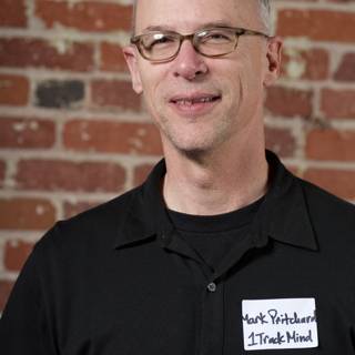 Bald Man with Glasses and Black Shirt