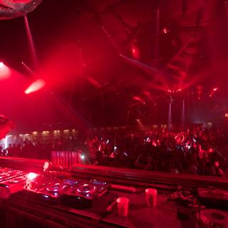 Red-Lit Concert with DJ and Crowd