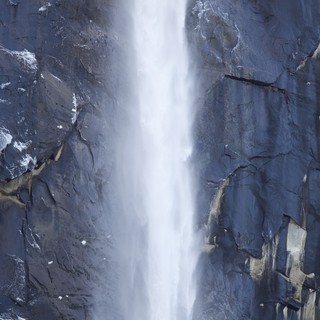 Cascading Waterfall Through Dramatic Granite Cliffs in Winter