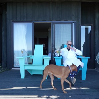 Man Relaxing with Dog on Modern Patio