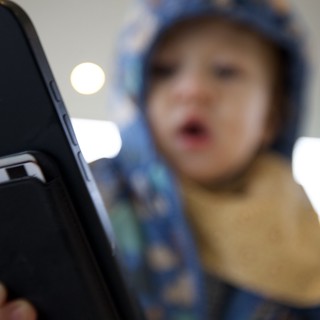 Blurred Selfie Portrait with Smartphone in Focus