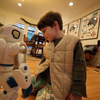 Young Child Interacting with Educational Robot at Home