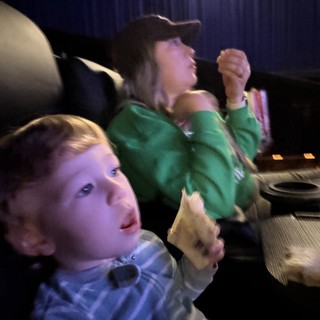 Children Engrossed in Movie Theater Entertainment