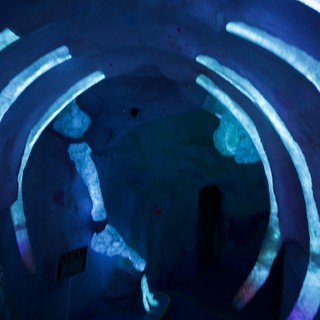 Immersive Blue Spiral Light Installation with Silhouettes
