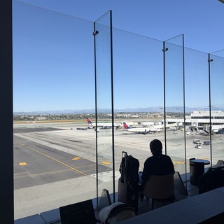 Silhouette Waiting at Airport Gate Overlooking Tarmac