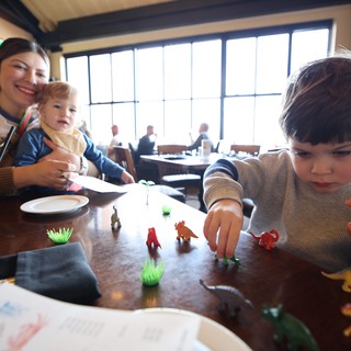 Family Mealtime with Dinosaur Play at Restaurant