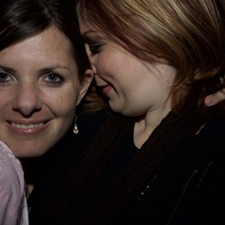 Two Friends Share a Whispered Secret at Night