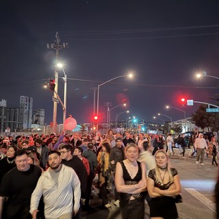 Night Crowd at Urban Street Intersection with Red Traffic Lights