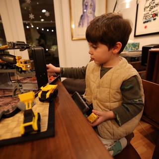 Young Child Playing with Construction Toy Set at Home