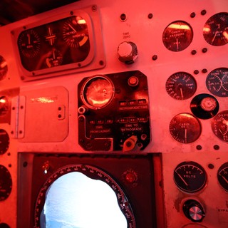 Vintage Spacecraft Control Panel Bathed in Red Light