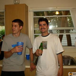 Two Men Enjoying Drinks in the Kitchen