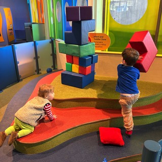 Children Playing with Giant Building Blocks in Museum Play Area