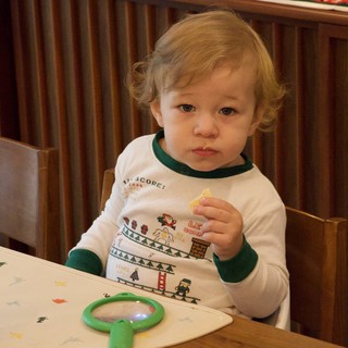 Toddler Enjoying Snack Time in Festive Gaming Shirt