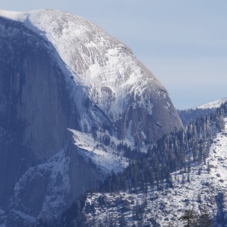Half Dome's Majestic Snow-Covered Granite Face in Winter
