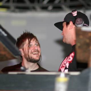 Two Men Laughing at a Music Event