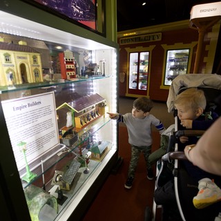 Children Exploring Model Train Display at Museum