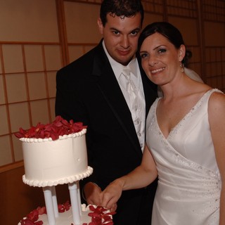 Bride and Groom Cut Wedding Cake Together