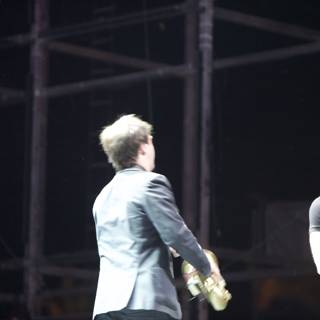 Two Men Rocking the Crowd with their Guitars