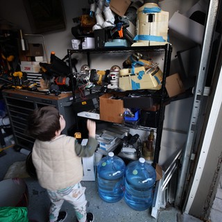 Child Organizing Tools in Cluttered Workshop Storage
