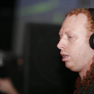 Red-haired man rocks out with headphones