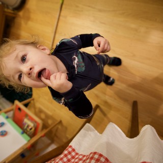 Joyful Toddler Enjoying Lollipop on Christmas Morning