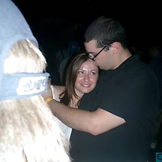 An Endearing Hug at a Nighttime Party