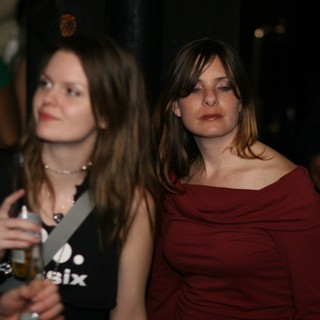 Two Women at a Dimly Lit Nightclub Event