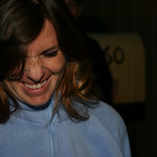 Candid Smile: Woman in Blue Fleece Looking Down