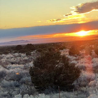Desert Sunset Over Sagebrush and Distant Mountains