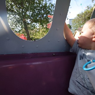Young Boy Looking Through Playground Structure Window