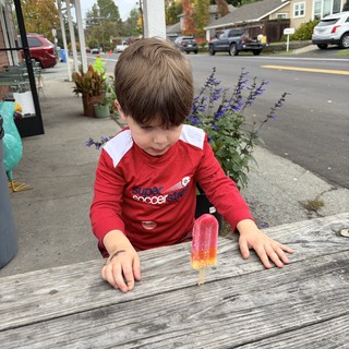 Young Boy Enjoying a Popsicle on a Fall Afternoon