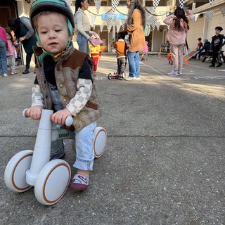 Young Child on Balance Bike at Neighborhood Party
