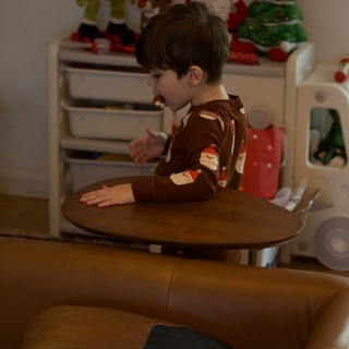 Young Boy in Festive Pajamas at Christmas Play Table