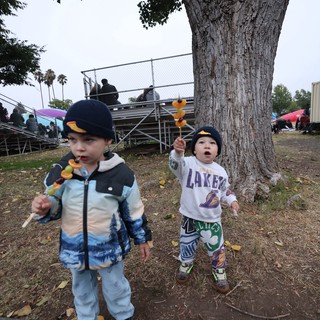 Two Young Boys Enjoy Fruit Skewers at Balloon Festival