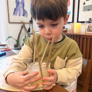 Young Boy Enjoying Iced Drink with Bamboo Straws