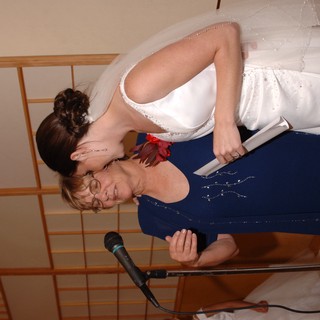 Bride and Elder Woman Share Tender Moment at Microphone