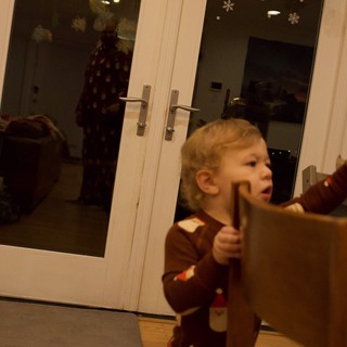 Young Child Opening French Doors on Christmas Day