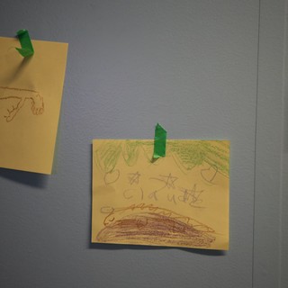 Children's Crayon Drawings Displayed on Gray Wall