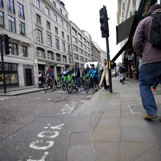 Cyclists on London Street with Classical Architecture