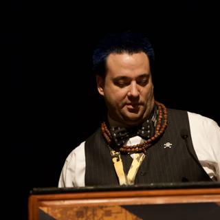 Blue-Haired Man at the Podium