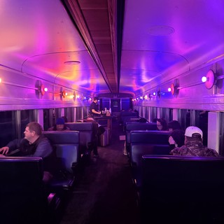 Purple-Lit Train Car Interior with Atmospheric Mood Lighting