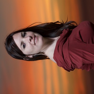 Woman in Red Against a Blazing Sunset Sky