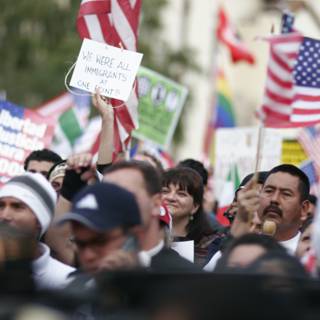 American and Mexican Flags Held by Crowd