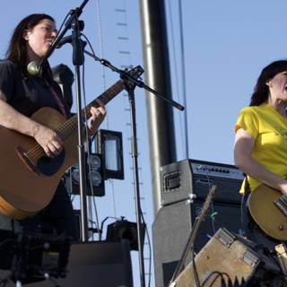 Musician Duo: Two Women Playing Guitar and Singing on Stage