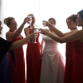 Elegant Toasting in Red Dresses