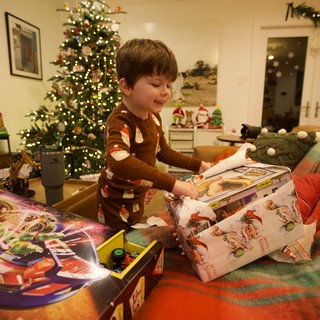 Christmas Morning Joy: Boy Unwrapping Presents