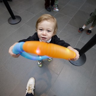 Toddler with Colorful Toy at Baby Rave Event